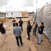 UC Riverside mechanical engineering undergrads gather outside the energy-efficient home they are building on Wednesday, January 10 2024, in an empty lot next to the SRC. (UCR/Stan Lim)