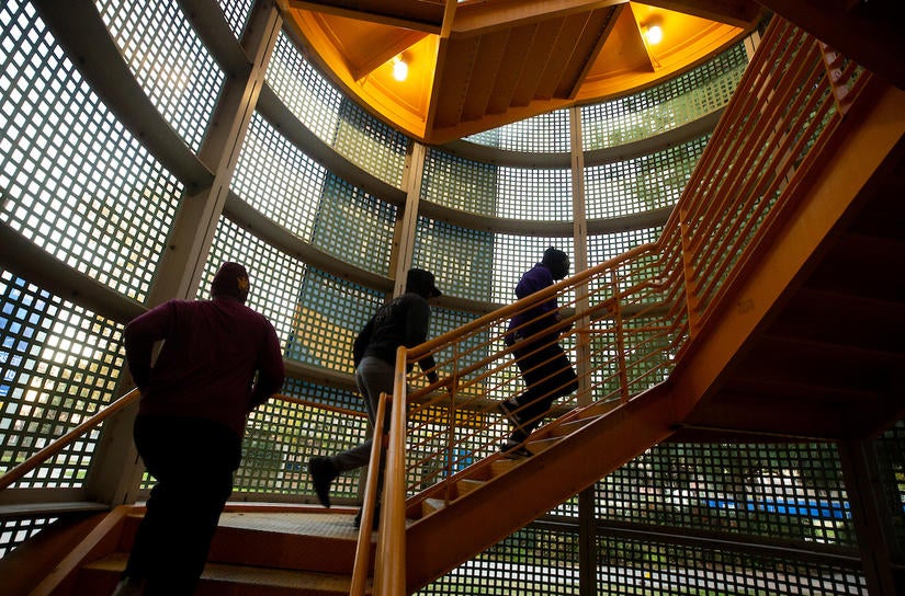 Barbershop Walk participants head up and down the College of Humanities, Arts, and Social Sciences yellow circular stairways. (UCR/Stan Lim)