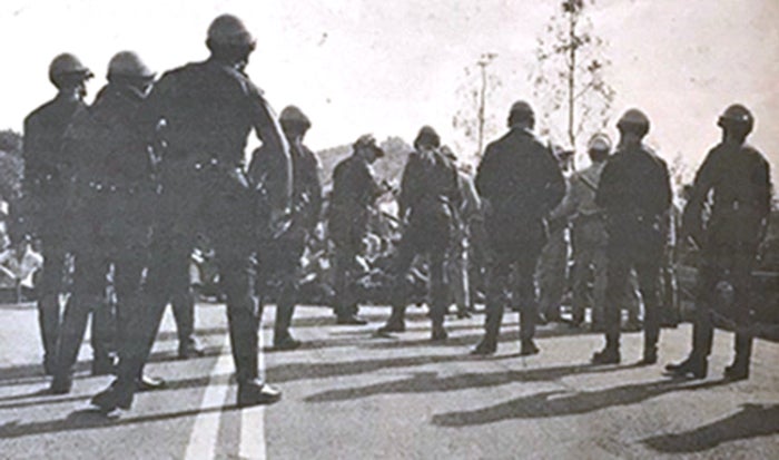 The police officers formed a “V” formation to clear the roadway by Fawcett.
