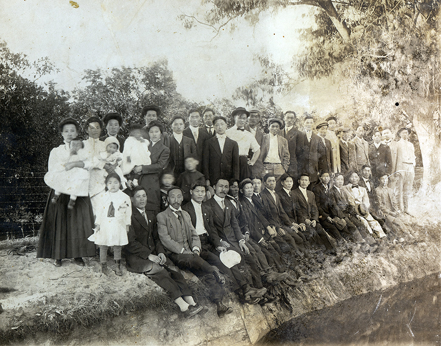 Group portrait of Koreans attending the 1911 Korean National Association of North American conference in Riverside, CA. The attendees are pictured near the Gage Canal. Dosan Ahn Chang Ho is seated fourth in the front row. Courtesy of Special Collections & Archives, UCR Libraries, University of California, Riverside.