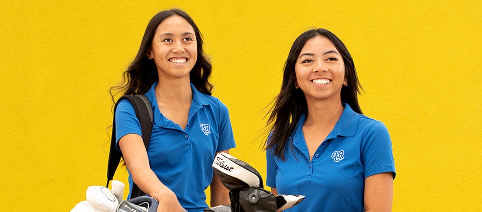 Photo of Tiffany and Nicole Le in their UCR golf uniform and gear