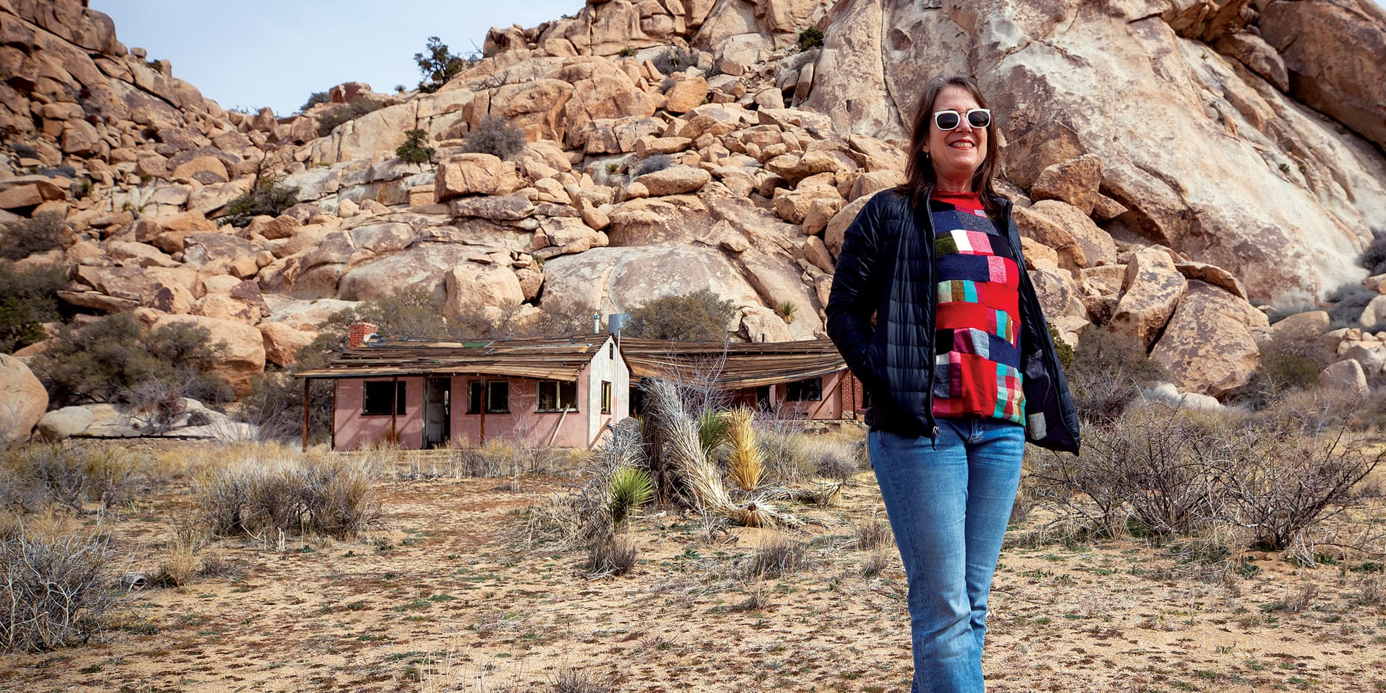 Gudis stands outside the Lost Horse Valley vacation property purchased by Arthur and Annie Case in 1953.