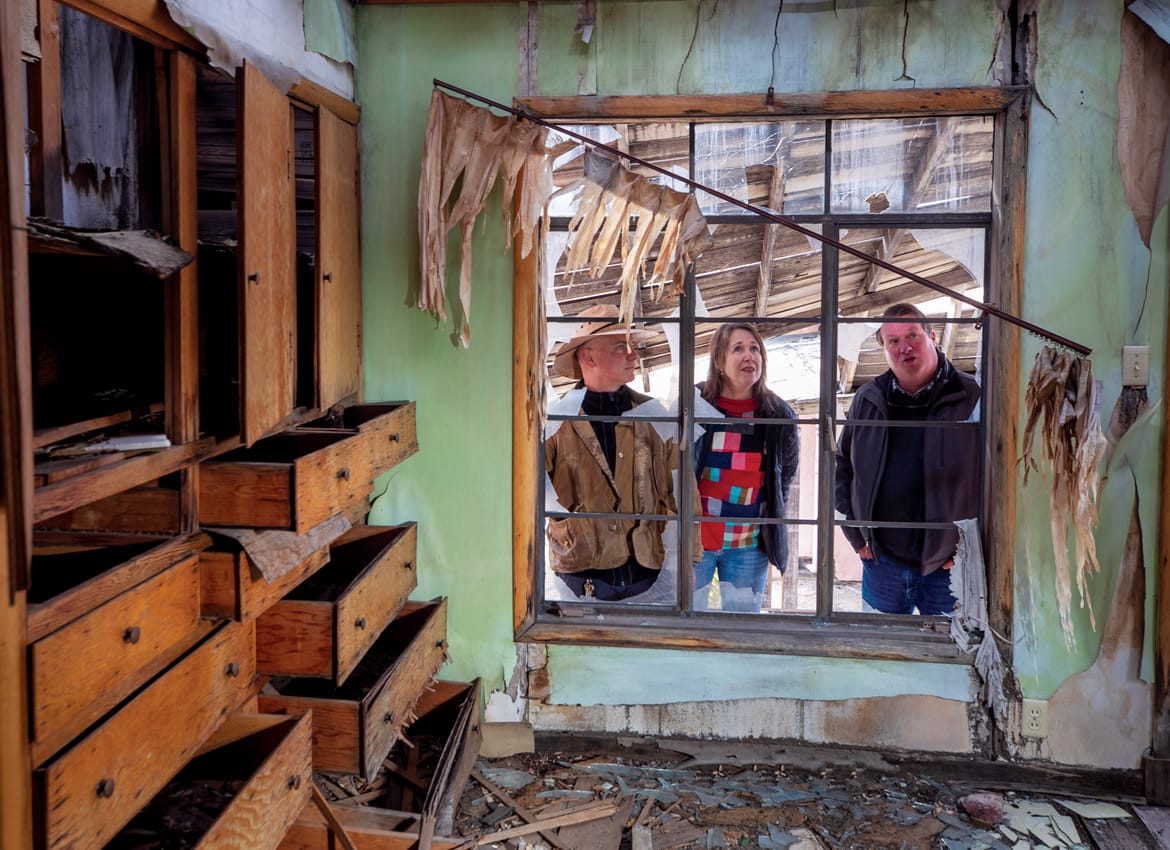 Researchers David Biggs, Catherine Gudis, and Todd Luce peer into what remains of the former Case family residence.