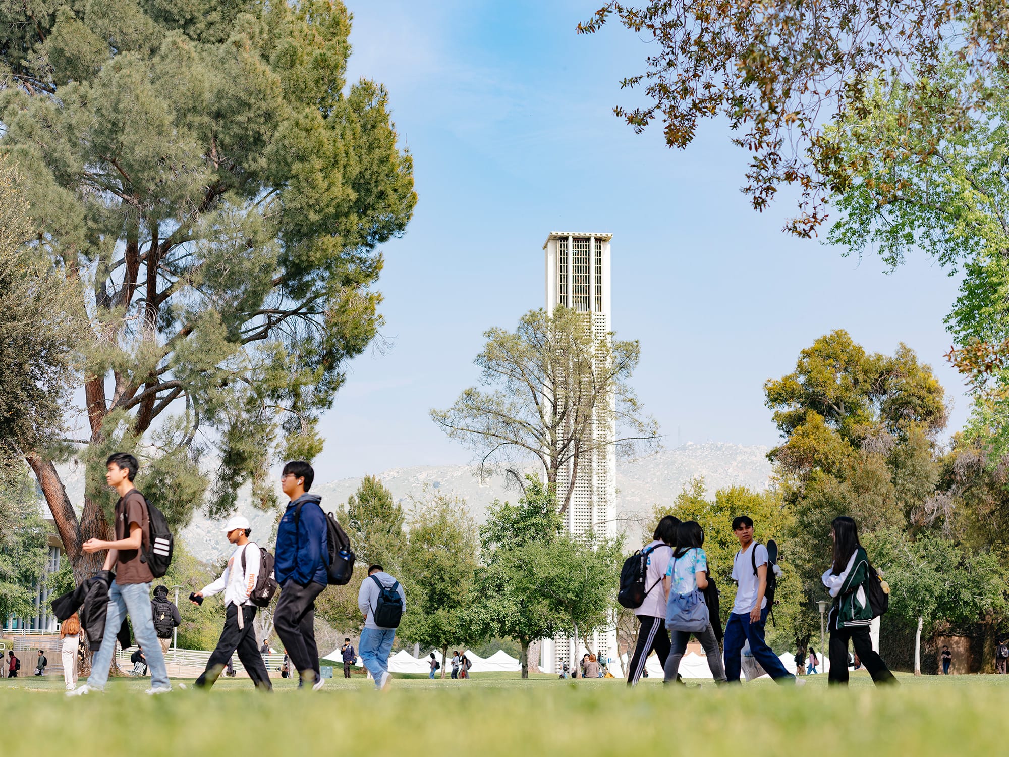 UCR students walking on campus near the Bell Tower
