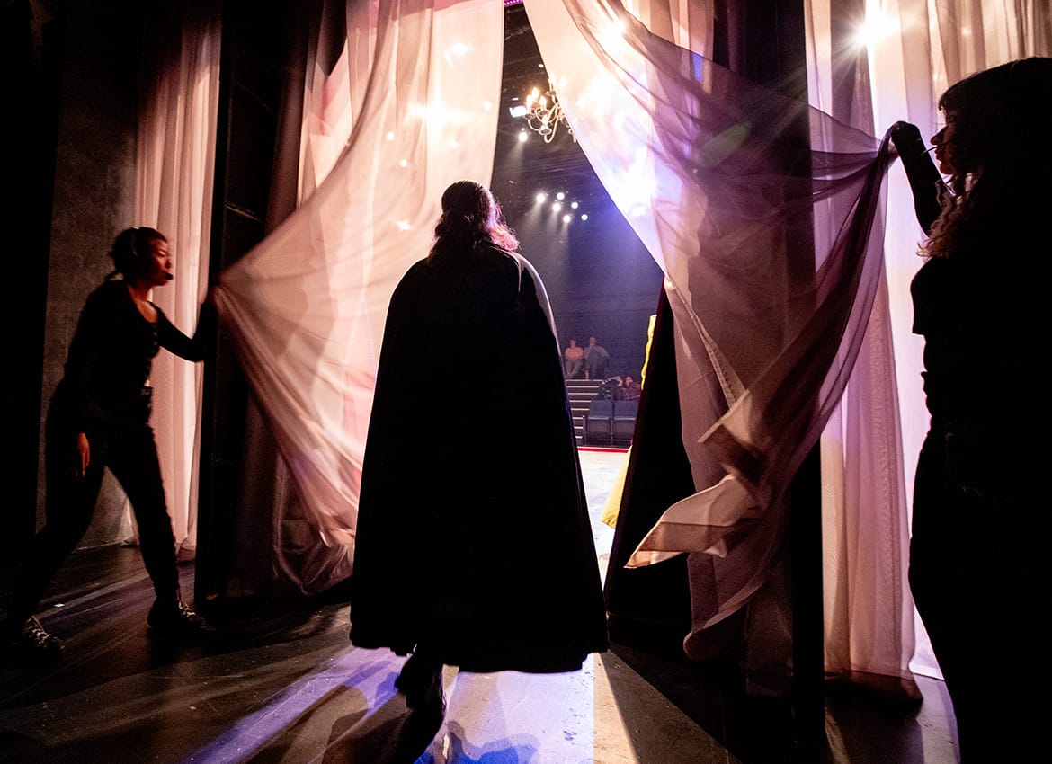 From left: Emily Luong, Eric Ortiz, and Alyssa Dupont practice Count Dracula’s grand entrance during the final dress rehearsal.