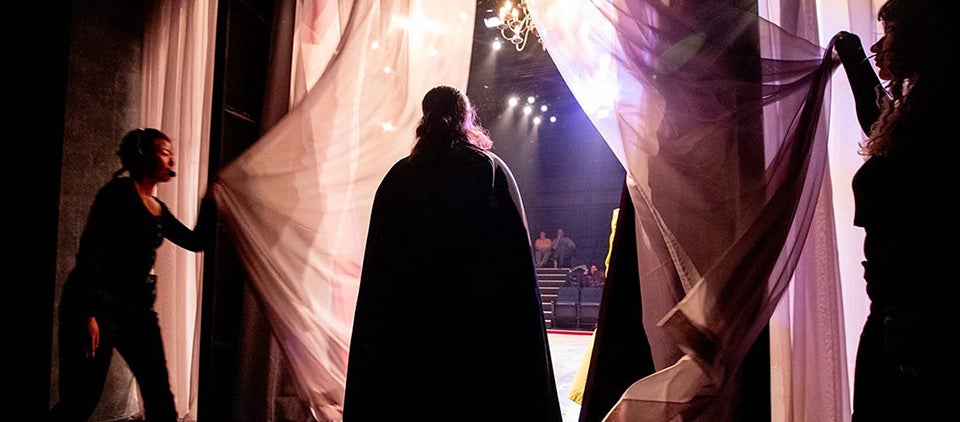 From left: Emily Luong, Eric Ortiz, and Alyssa Dupont practice Count Dracula’s grand entrance during the final dress rehearsal.