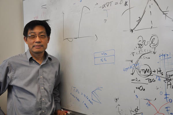 Jing Shi standing in front of white board