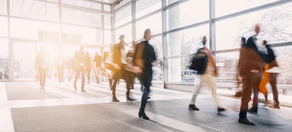 A blurry picture of people in business attire