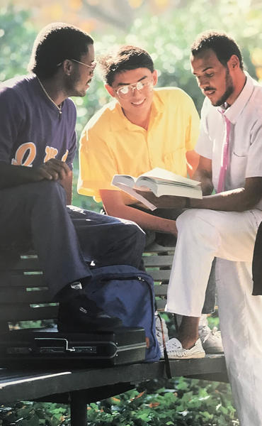 Jalani Bakari ’88 (in white) with a group of UCR students in the late 1980s.