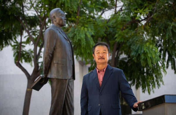 Edward T. Chang, professor of ethnic studies and founding director of the Young Oak Kim Center for Korean American Studies at UC Riverside. He stands in front of the statue of Korean independence activists, Dosan Ahn Chang Ho in downtown Riverside on May 26, 2021. (UCR/Stan Lim)
