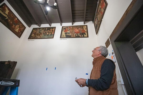 History professor Steven Hackel, looks at artwork being installed at Mission San Gabriel Museum in San Gabriel on Friday, June 26, 2023. Hackel is the exhibition's lead curator. (UCR/Stan Lim)