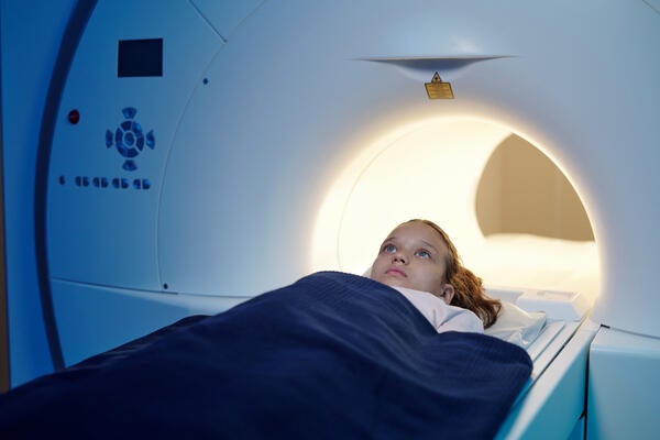 Child moving into an MRI scan machine