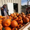 Richard Zapien, R'Garden manager rinses off soil from the pumpkins on September 25, 2019. (UCR/Stan Lim)