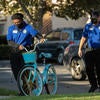 Community Service Officers William Robinson, left, and Fernando Carrillo, both student employees with the University of California Riverside Police Department, arrive with a bike to be donated to children living at Oban Family Housing at UC Riverside on Friday, September 17, 2021. (UCR/Stan Lim)