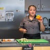 Chef Val shows cooking class a bell pepper