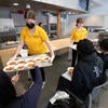 Student sous chefs pass out samples to class