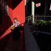 Band member Dafne Camila Gallardo Vásquez is dressed and ready to perform as she waits for others at Gallardo Martínez's home.