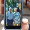Carl Cranor shows a photo on his cellphone. It's him standing next to David Kaplan, the UCLA philosophy professor who recruited Cranor to UCLA's doctoral program in 1971. Cranor visited Kaplan on Sunday, June 9, 2024 for an annual end of school year gathering. (UCR/Sandra Baltazar Martinez)