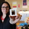 Sonja Sekely-Rowland, visual resource collection curator at UC Riverside's Department of the History of Art holds a 35mm image of Antigua Guatemala. (UCR/Sandra Baltazar Martínez) 