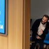 Presenter peeking out at 2025 Grad Slam Final audience