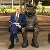 Wilcox sits on a bench next to a statue of Scotty in December 2018.