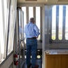 Wilcox peers out at the UCR campus from the top of the bell tower in April 2025.