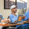 Student Jose Luis Martinez (center) participates in a class discussion with fellow classmates at the Norco facility.