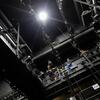 Student AV technicians on a catwalk work together on the stage lighting for the upcoming performance of “Dracula: A Comedy of Terrors”.