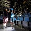 Student AV technicians work together on the stage lighting for the upcoming performance of “Dracula: A Comedy of Terrors”.