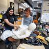 Nhaomi Vasquez, 4th Year TFDP, left, and Giselle Manzano 4th Year TFDP, work together dressing a prop for the upcoming performance of “Dracula: A Comedy of Terrors”.