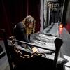 Crew member Alyssa DuPont, 4th Year Education/TFDP, preps a stage prop backstage before their final dress rehearsal.