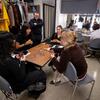 Crew members in the dressing room play Bandido, a card game, as they pass the time before their final dress rehearsal.