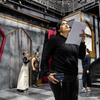 Student Nhaomi Vasquez (front) checks lighting while the cast prepares for the stage.