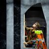 Aubrey Jerue, one of the few students trained to use heavy machinery and equipment, builds the inner supports of the window frames.