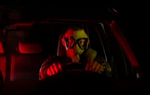 man in gas mask, driving