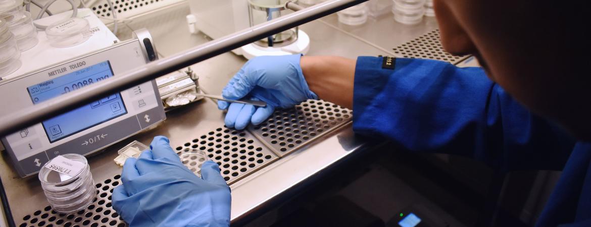 UC Riverside chemical and environmental engineering graduate student Anthony Gerigk weighs the final mass of emissions on a teflon filter.