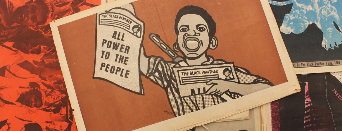 Image of artwork by Emory Douglas featuring a boy holding a paper that reads "All Power to the People". Photo by Essence Harden. Archives of Southern California Library