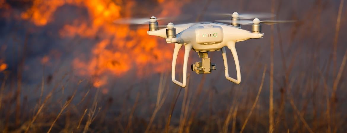 A drone hovers near a wildfire