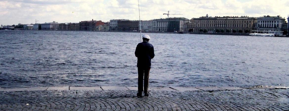 Fisherman against skyline of Leningrad, USSR, now St. Petersburg, Russia