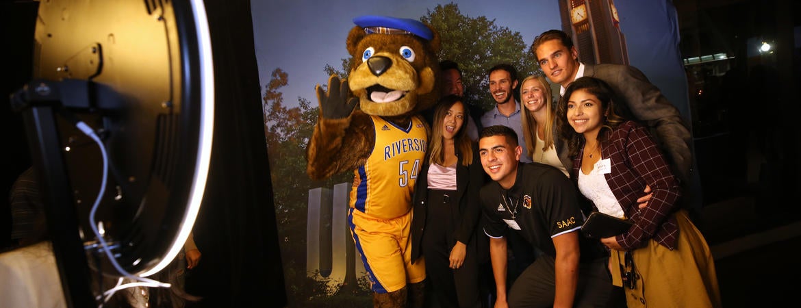 Alumni with Scotty the Bear