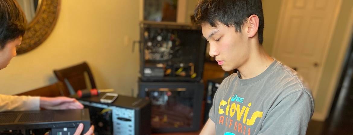 Freshman computer science student Ervin Young building a computer for low-income students