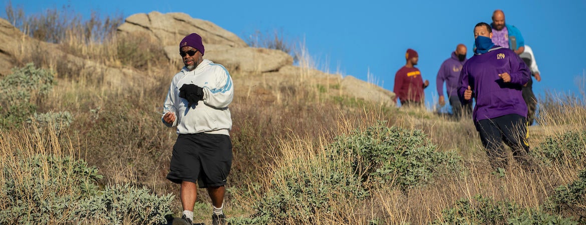 Barbershop Walk participants head down a hill, led by Bert Wright. (UCR/Stan Lim)