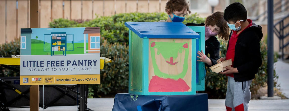 Children painting the Free Little Pantry on Thursday, March 11, 2021, at the Oban Family Housing. (UCR/Stan Lim)