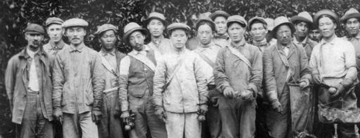 Pachappa Camp residents in front of Riverside citrus groves. Photo courtesy of the Korean American digital archive at USC.