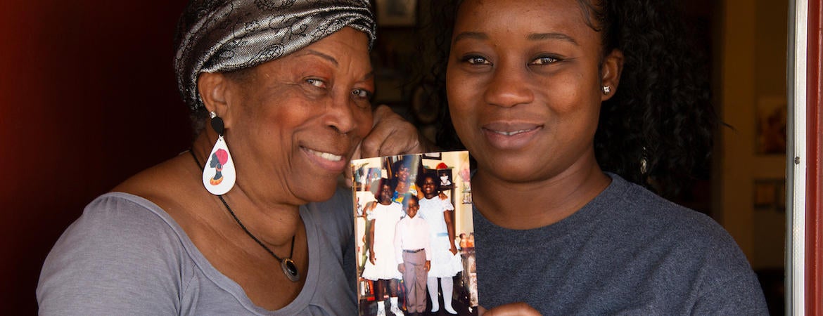 Deidre Reyes, 46, holds a family photo with her mother, Sally Reyes, 71, during a visit to her home in Los Angeles on March 24, 2021. (UCR/Stan Lim)