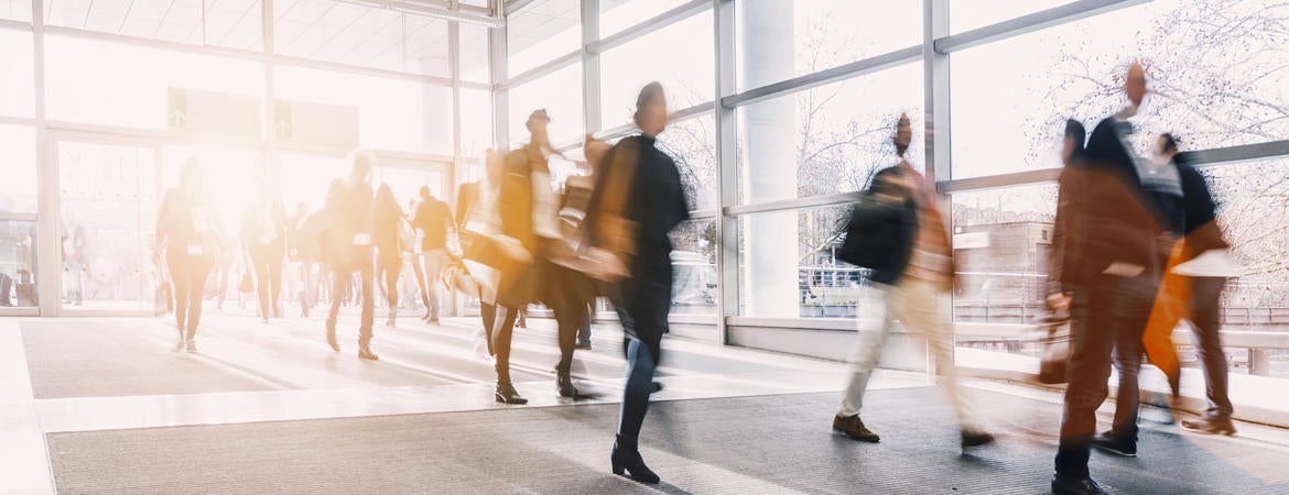 A blurry picture of people in business attire