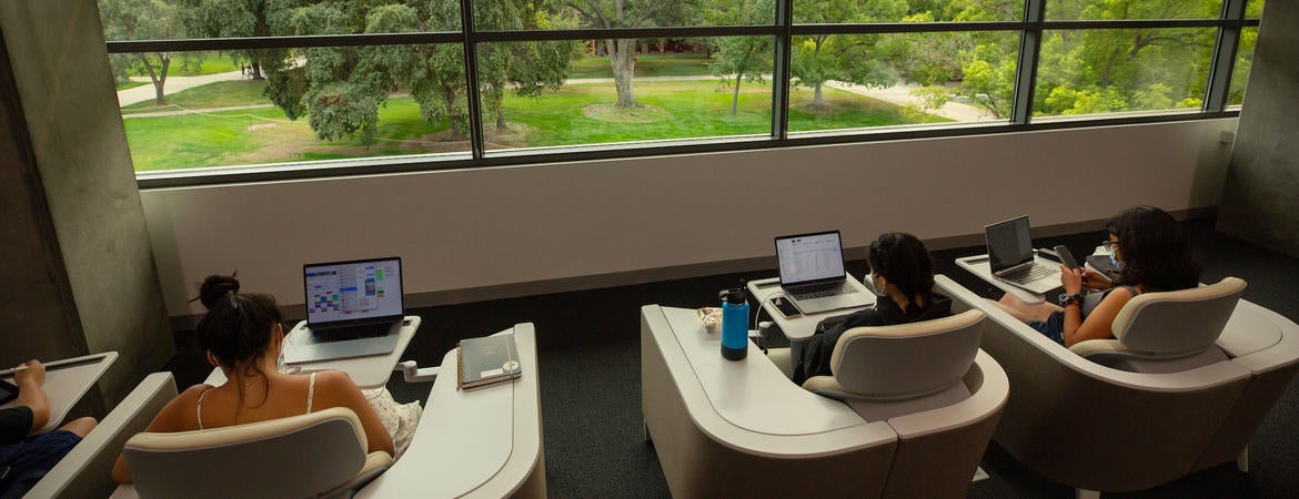 Students studying at UCR Student Success Center's study cubbies.