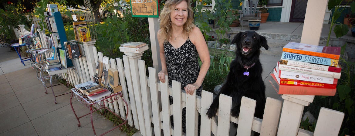 UCR Distinguished Professor Susan Straight in her front yard with her dog Angel on July 27, 2020, in Riverside. (UCR/Stan Lim)