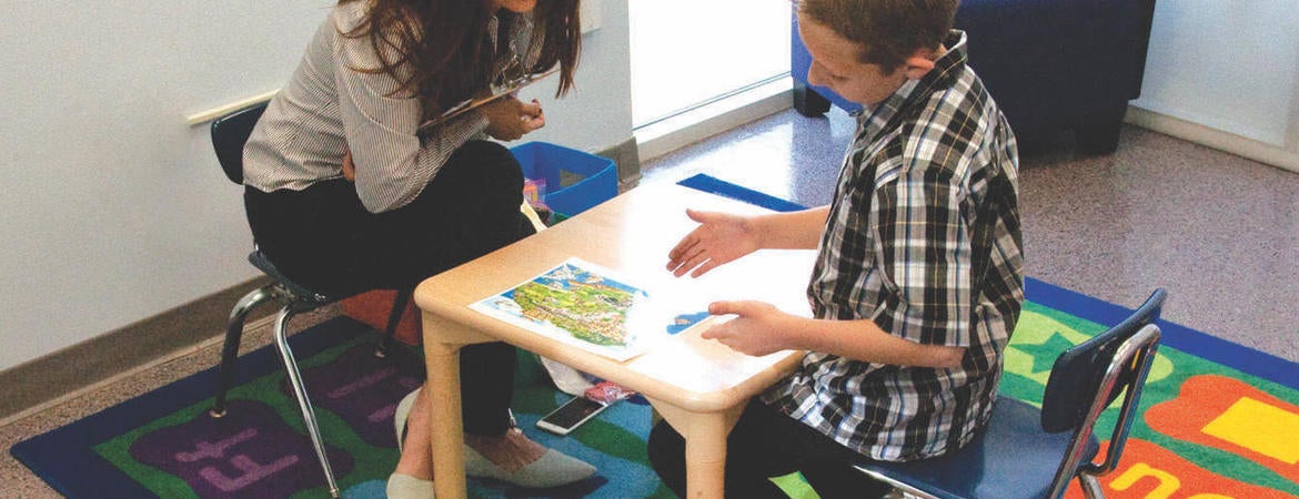 A UCR SEARCH Center staffer works with an autistic child