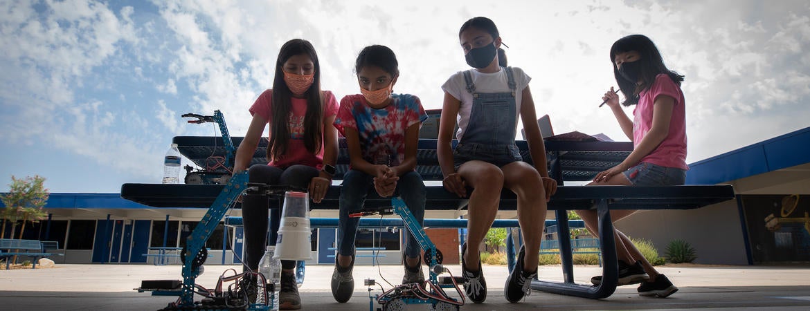 Middle school girls watch a robot they made at a UC Riverside summer robotics camp